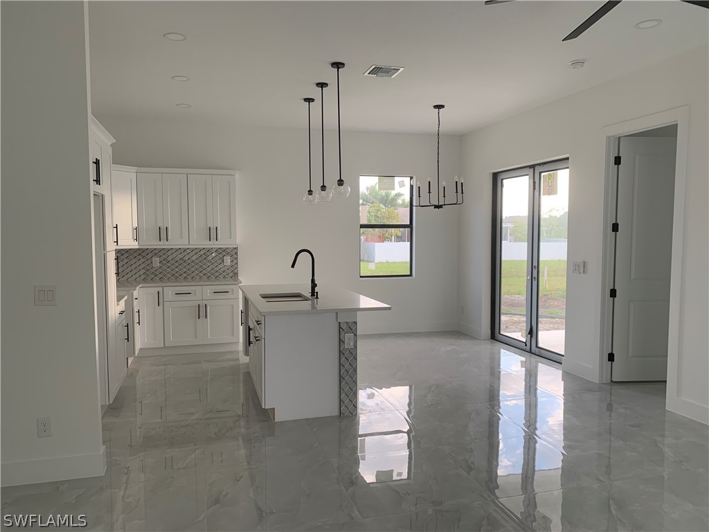 526 Raintree Street East Lehigh Acres, FL 33974 - Photo 4 of 21 a kitchen with refrigerator and window