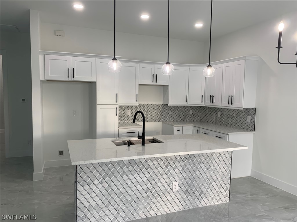 526 Raintree Street East Lehigh Acres, FL 33974 - Photo 8 of 21 a kitchen with stainless steel appliances granite countertop a sink a refrigerator and a stove