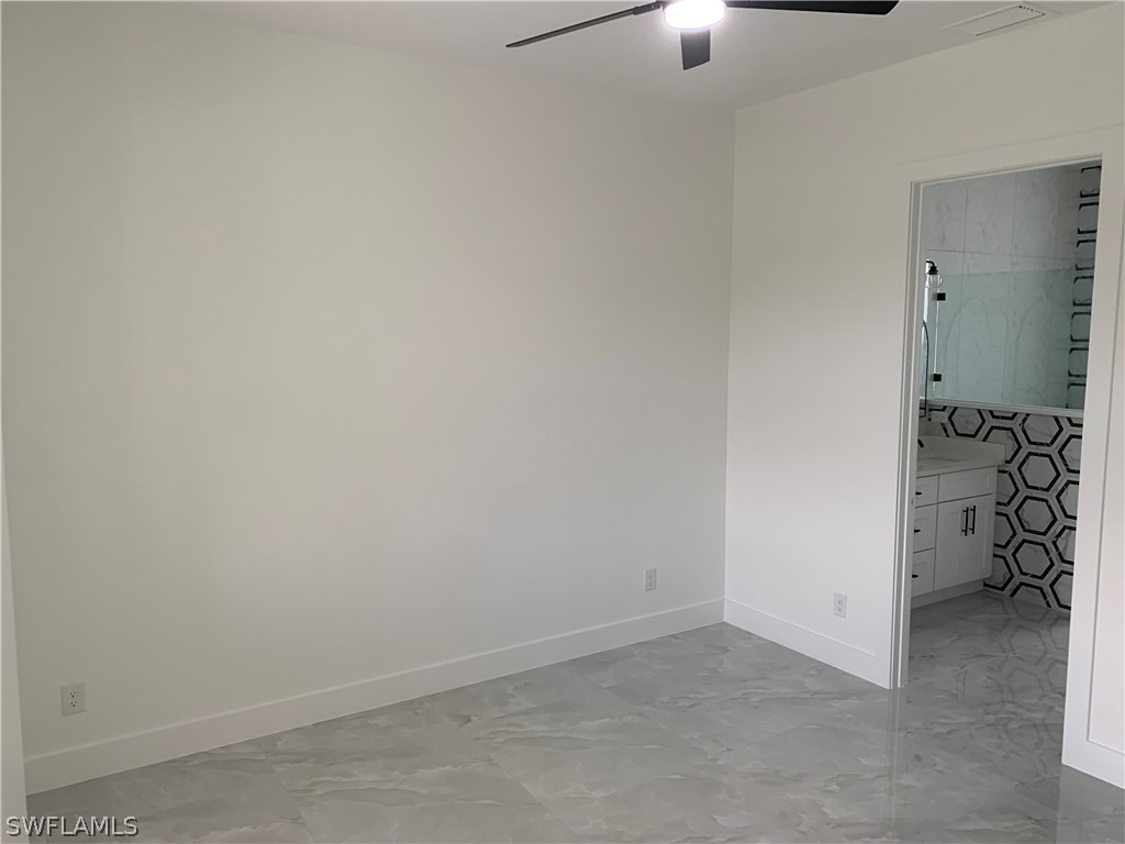 526 Raintree Street East Lehigh Acres, FL 33974 - Photo 10 of 21 an empty room with a ceiling fan