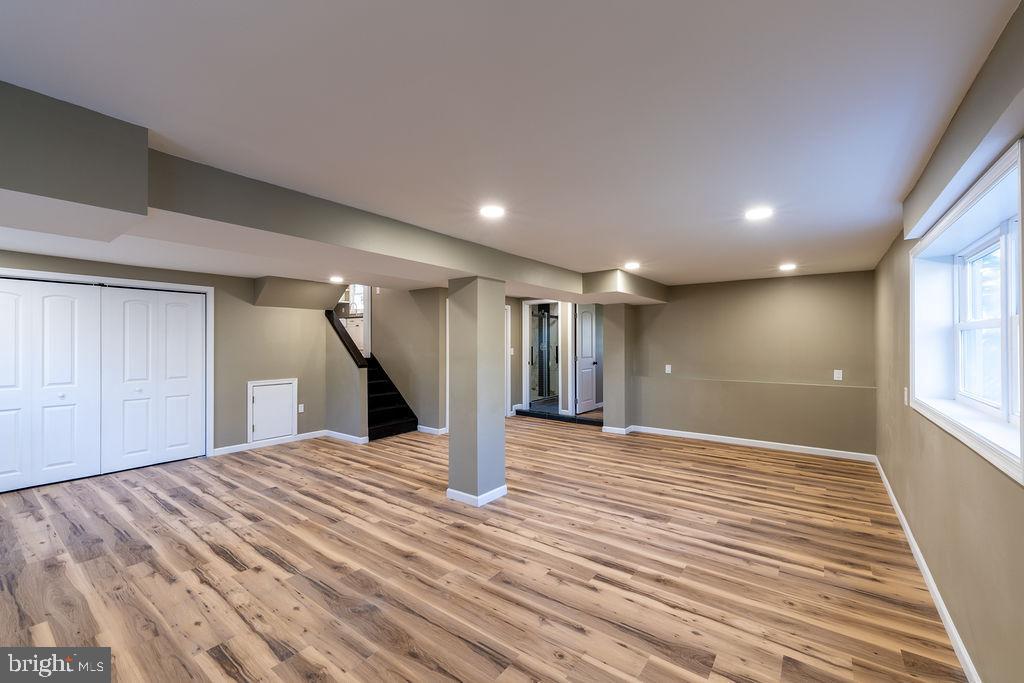 706 Center Street Kennett Square, PA 19348 - Photo 11 of 39 a view of an empty room with wooden floor and a window
