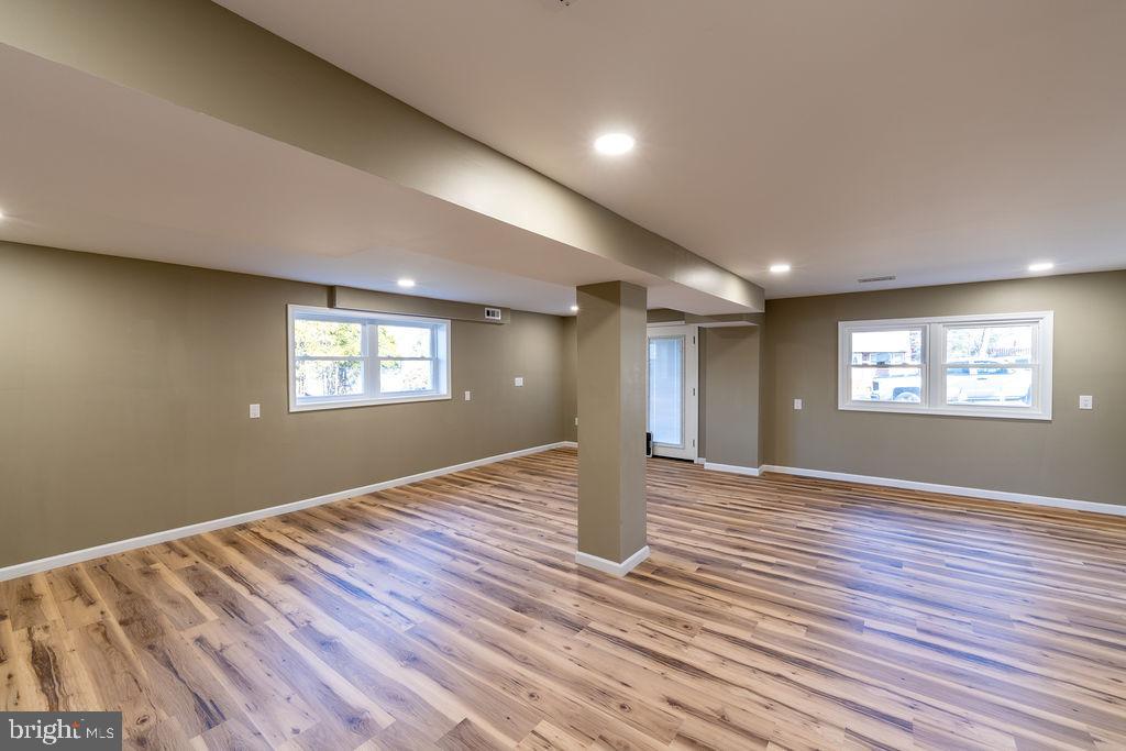706 Center Street Kennett Square, PA 19348 - Photo 13 of 39 a view of an empty room with wooden floor and a window
