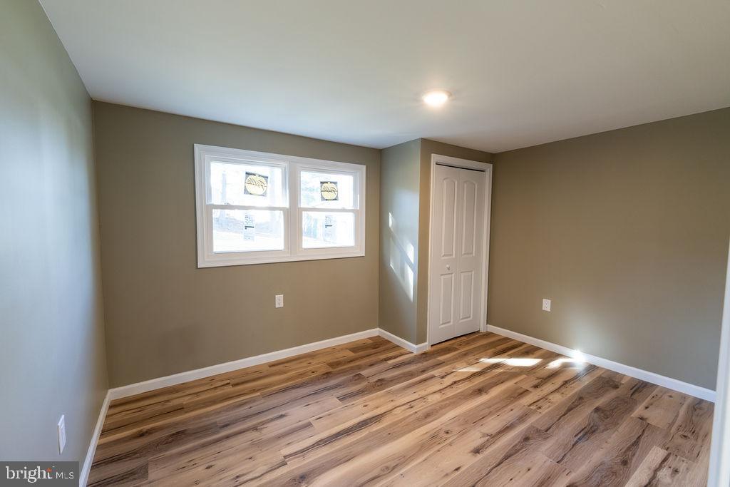 706 Center Street Kennett Square, PA 19348 - Photo 15 of 39 a view of a big room with wooden floor and windows