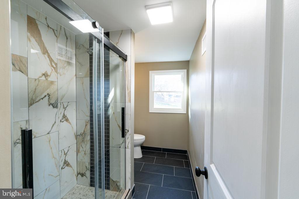 706 Center Street Kennett Square, PA 19348 - Photo 17 of 39 a bathroom with a granite countertop shower