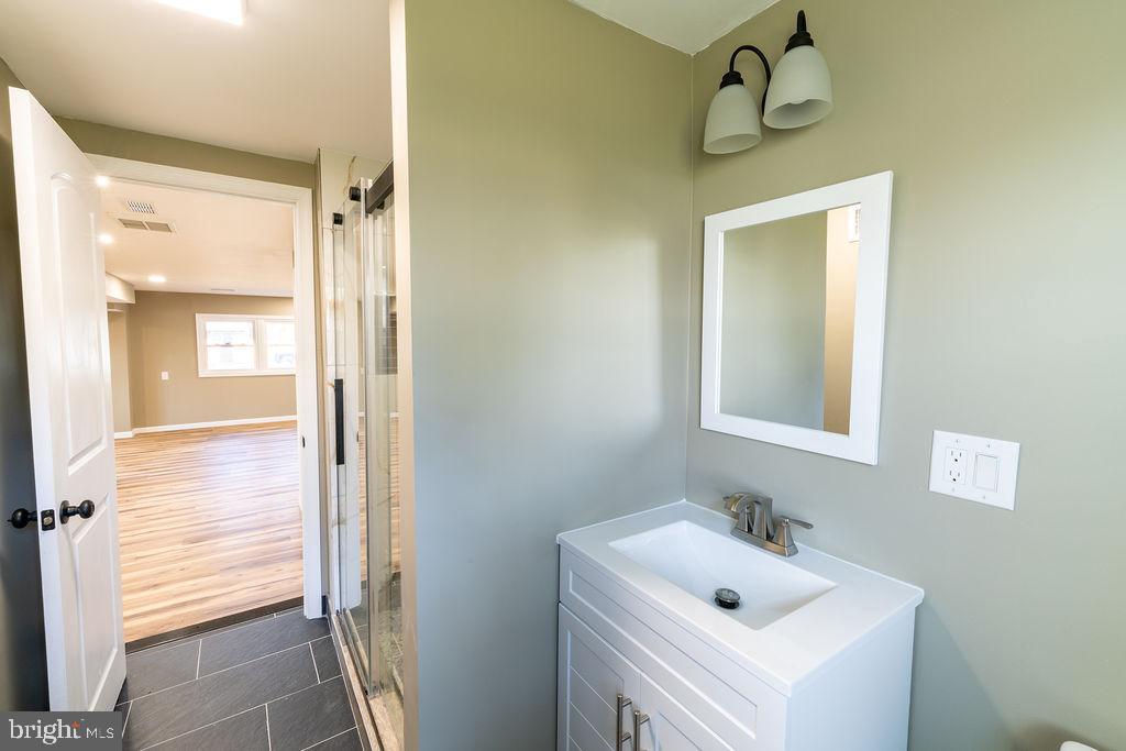 706 Center Street Kennett Square, PA 19348 - Photo 18 of 39 a bathroom with a sink and mirror