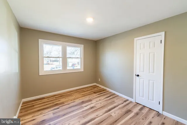 a view of a room with wooden floor and window