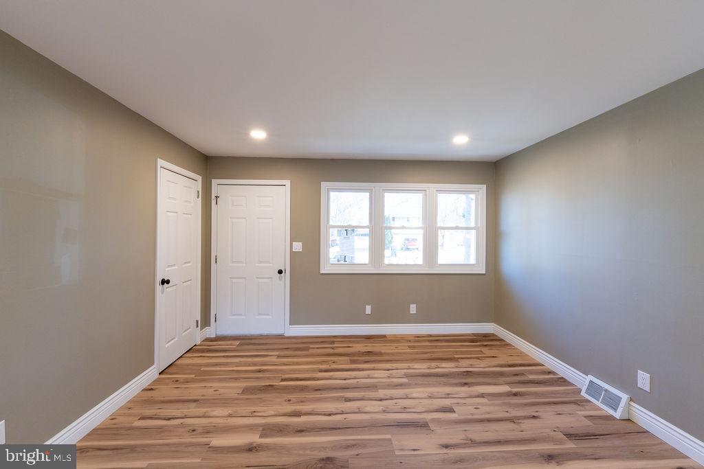 706 Center Street Kennett Square, PA 19348 - Photo 3 of 39 a view of empty room with wooden floor and fan