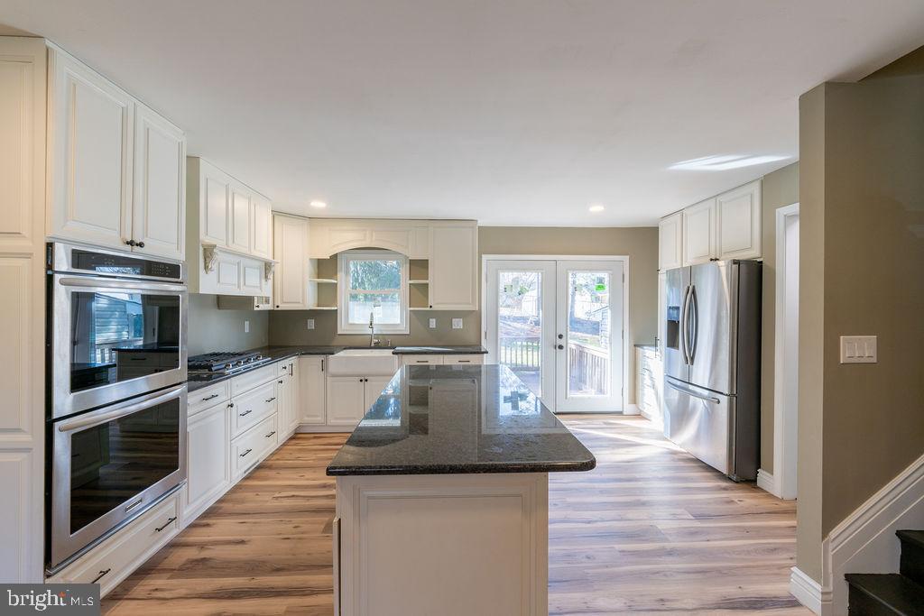 706 Center Street Kennett Square, PA 19348 - Photo 6 of 39 a kitchen with stainless steel appliances granite countertop a refrigerator a stove microwave and cabinets