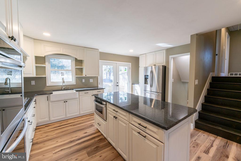 706 Center Street Kennett Square, PA 19348 - Photo 7 of 39 a kitchen with stainless steel appliances granite countertop a sink and a refrigerator