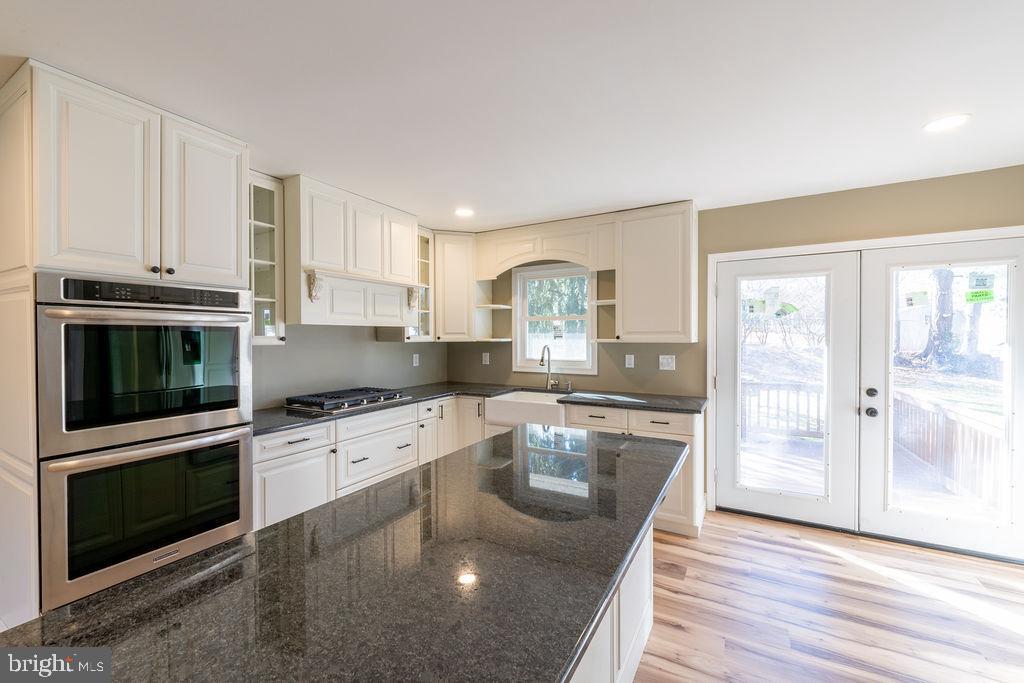 706 Center Street Kennett Square, PA 19348 - Photo 8 of 39 a kitchen with granite countertop a stove top oven and sink