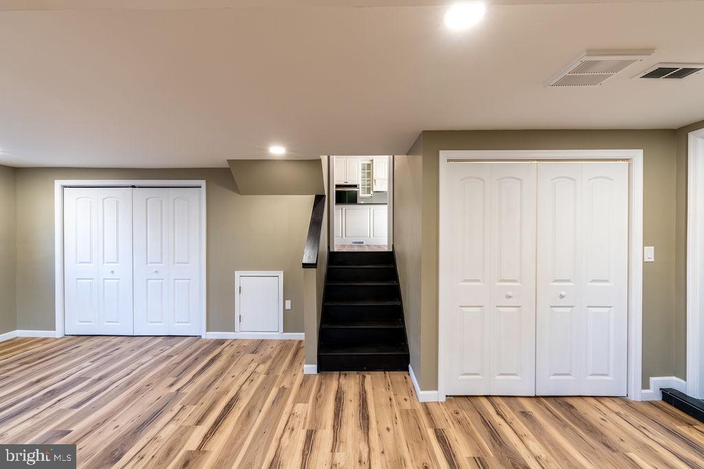 706 Center Street Kennett Square, PA 19348 - Photo 9 of 39 a view of a bedroom with wooden floor and stairs