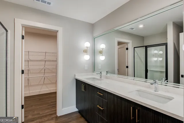a bathroom with a double vanity sink and a mirror