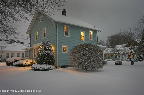 a couple of cars parked in front of a house