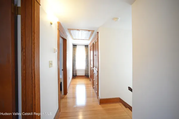 a view of a hallway with wooden floor