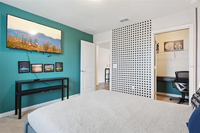 a bedroom with a bed chair and a window