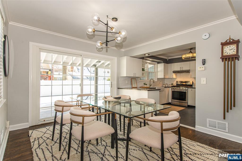 1169 Broad Street Bloomfield, NJ 07003 - Photo 13 of 47 a dining room with furniture a chandelier and kitchen view