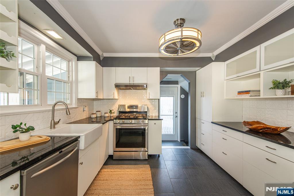 1169 Broad Street Bloomfield, NJ 07003 - Photo 20 of 47 a kitchen with stainless steel appliances granite countertop a sink and a stove