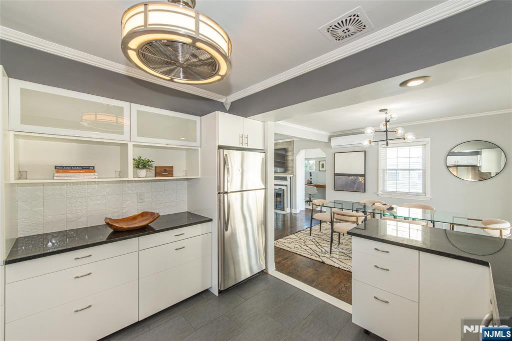 1169 Broad Street Bloomfield, NJ 07003 - Photo 23 of 47 a kitchen with granite countertop a white cabinets and refrigerator
