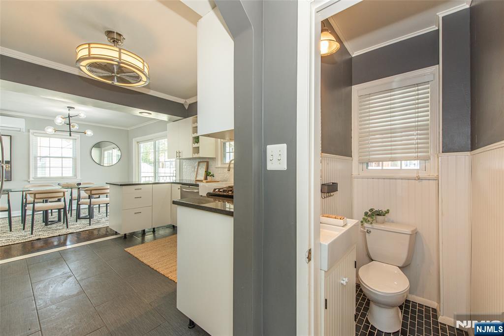 1169 Broad Street Bloomfield, NJ 07003 - Photo 24 of 47 a bathroom with a toilet a sink and a mirror
