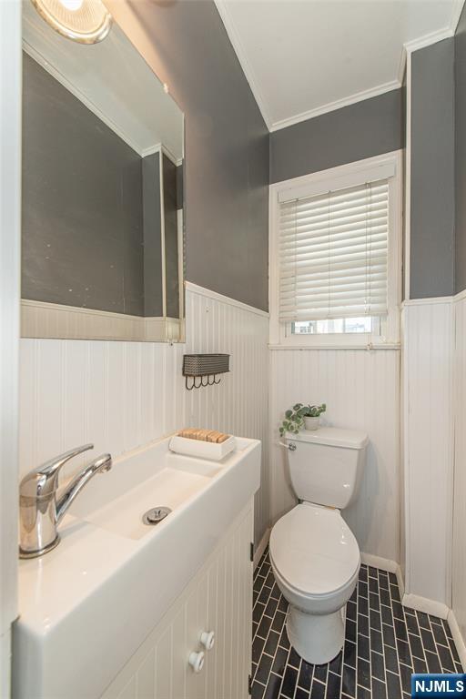 1169 Broad Street Bloomfield, NJ 07003 - Photo 25 of 47 a bathroom with a sink toilet and mirror