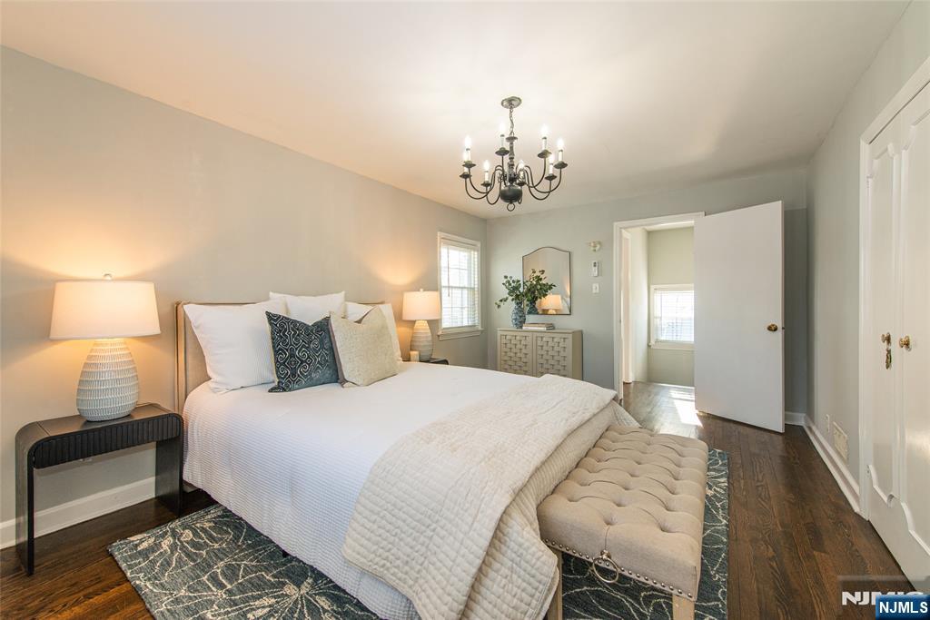 1169 Broad Street Bloomfield, NJ 07003 - Photo 27 of 47 a spacious bedroom with a bed and a lamp