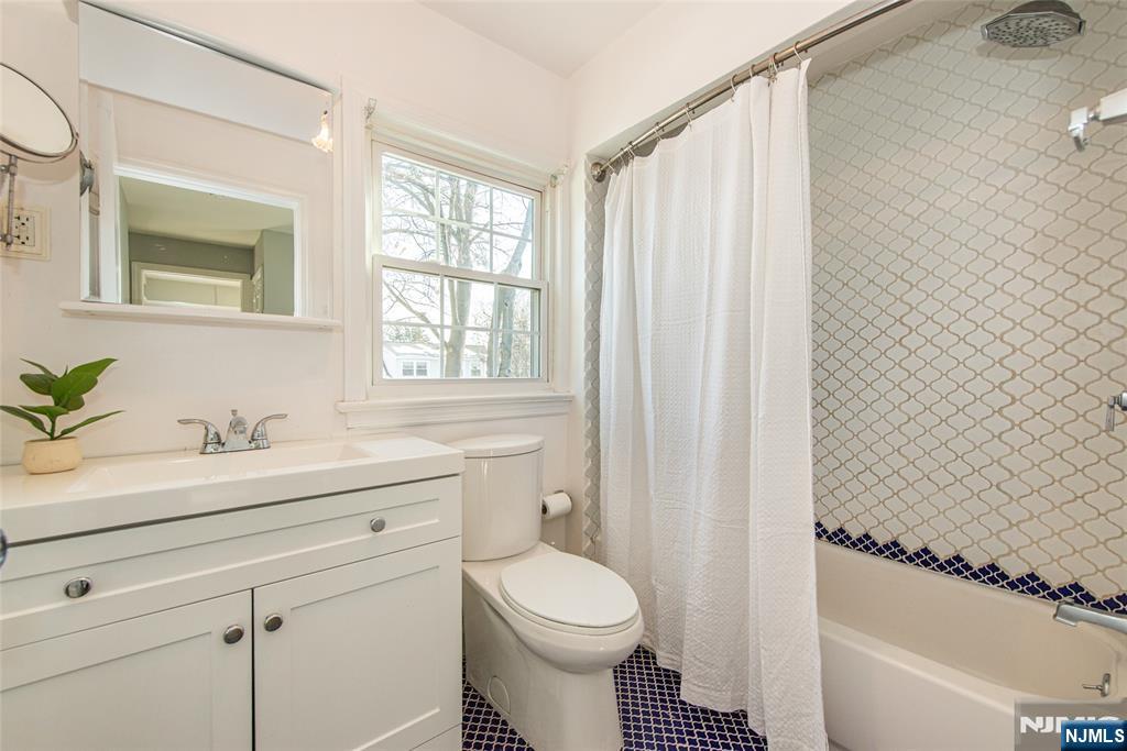 1169 Broad Street Bloomfield, NJ 07003 - Photo 32 of 47 a bathroom with a sink a toilet and tub