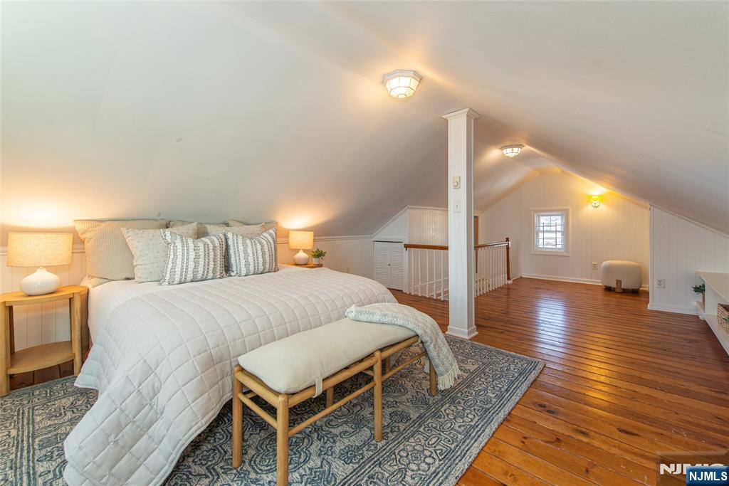 1169 Broad Street Bloomfield, NJ 07003 - Photo 33 of 47 a spacious bedroom with a bed and wooden floor