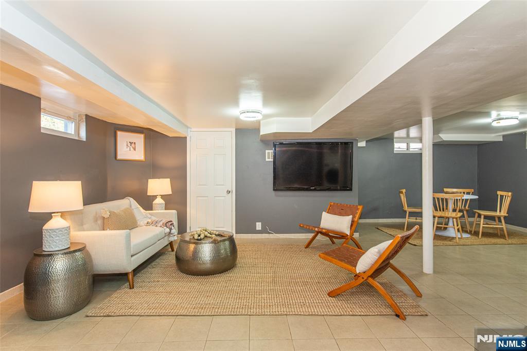 1169 Broad Street Bloomfield, NJ 07003 - Photo 36 of 47 a living room with furniture and a flat screen tv