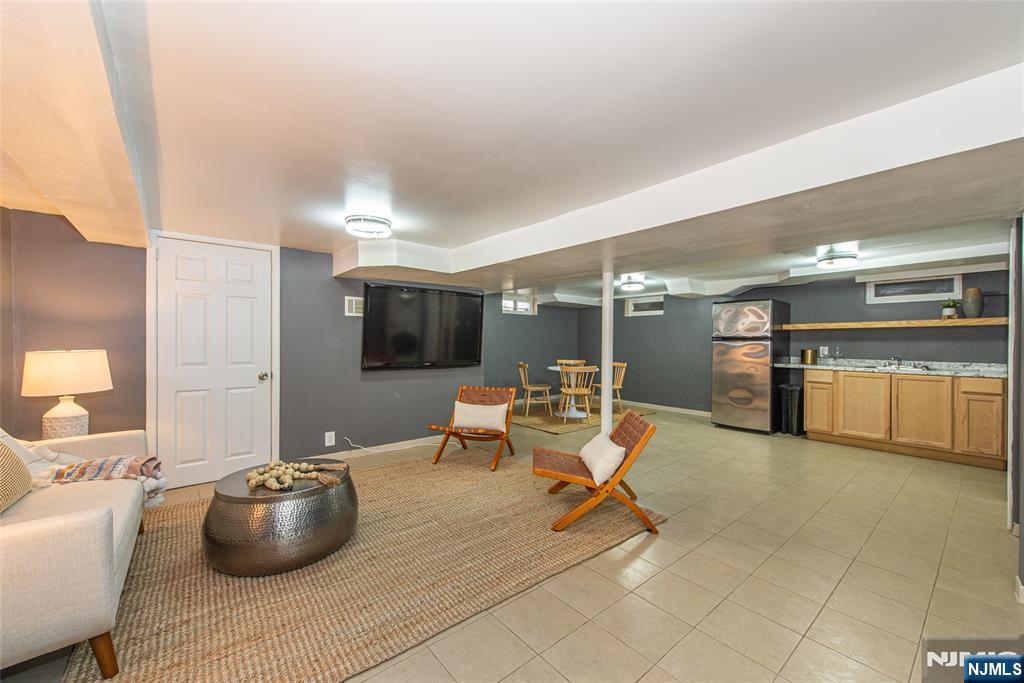 1169 Broad Street Bloomfield, NJ 07003 - Photo 37 of 47 a living room with furniture and a flat screen tv