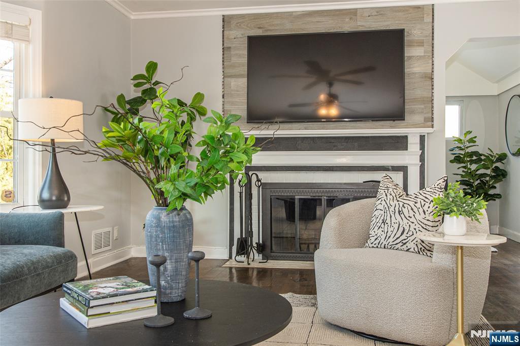 1169 Broad Street Bloomfield, NJ 07003 - Photo 9 of 47 a living room with furniture and a fireplace