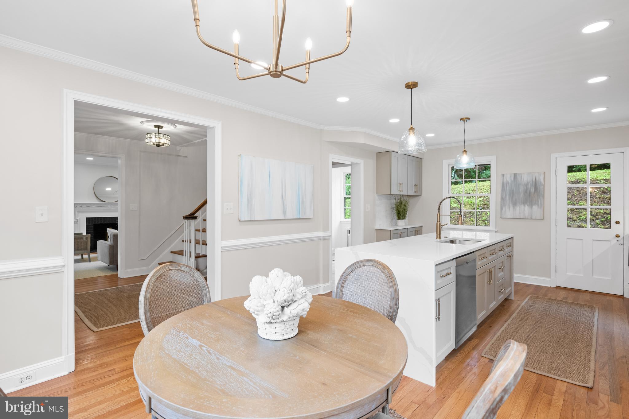 7819 Overbrook Road Ruxton, MD 21204 - Photo 11 of 80 a kitchen with stainless steel appliances kitchen island granite countertop a dining table chairs and a wooden floor