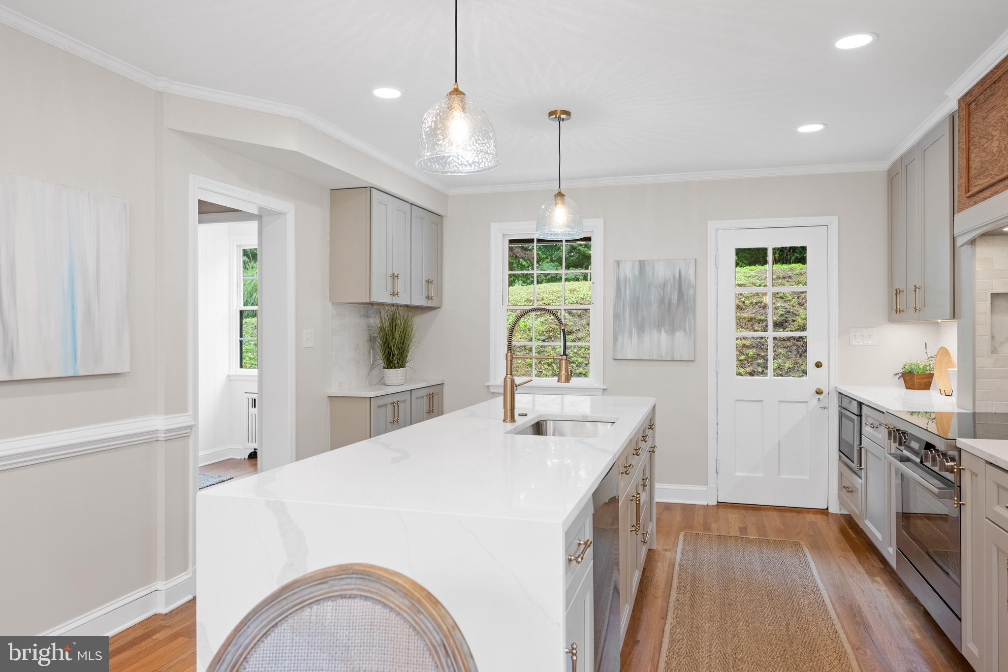 7819 Overbrook Road Ruxton, MD 21204 - Photo 18 of 80 a kitchen with a stove a sink a center island and wooden floor
