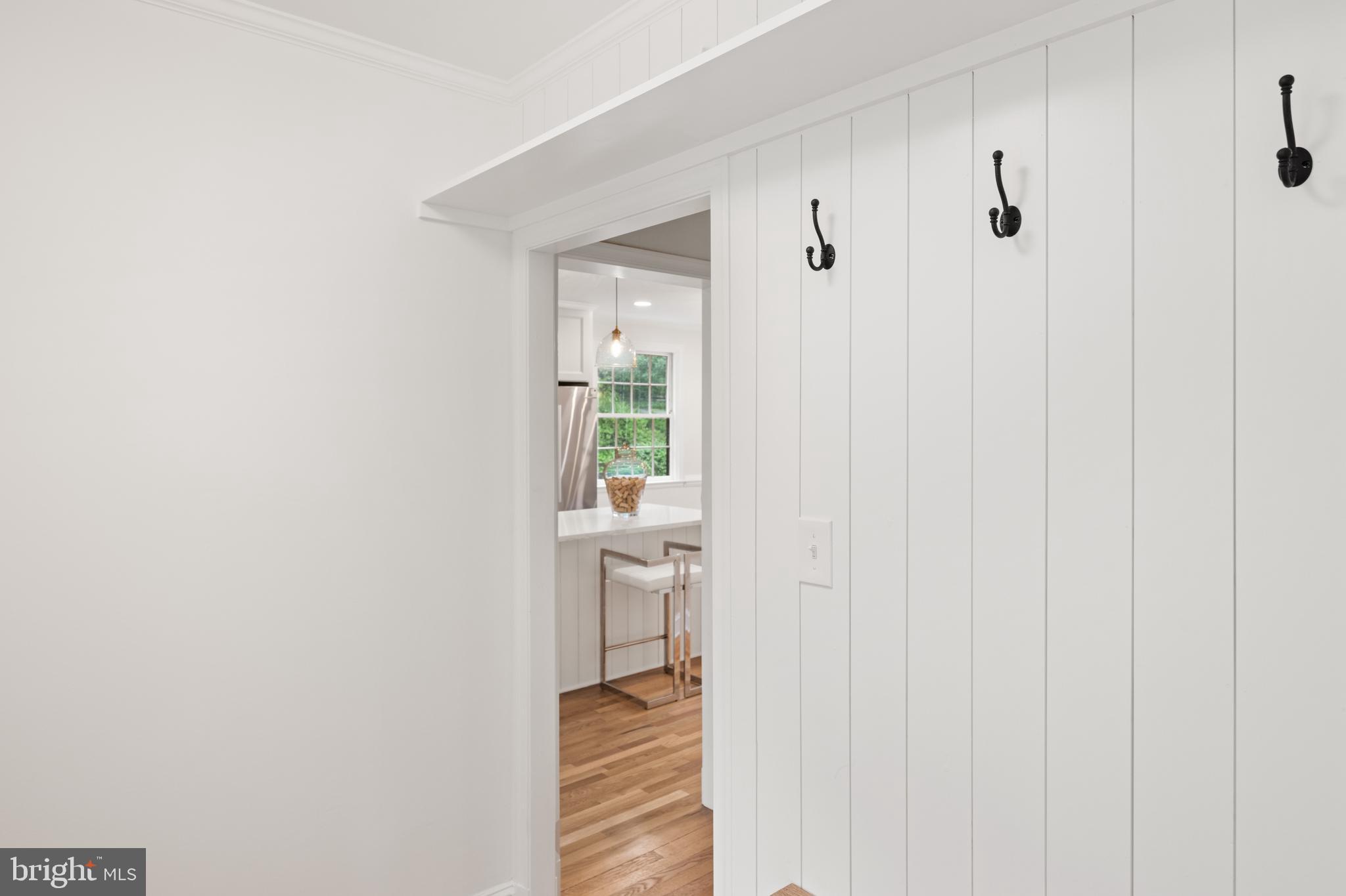 7819 Overbrook Road Ruxton, MD 21204 - Photo 25 of 80 a view of a hallway with wooden floor and a bathroom