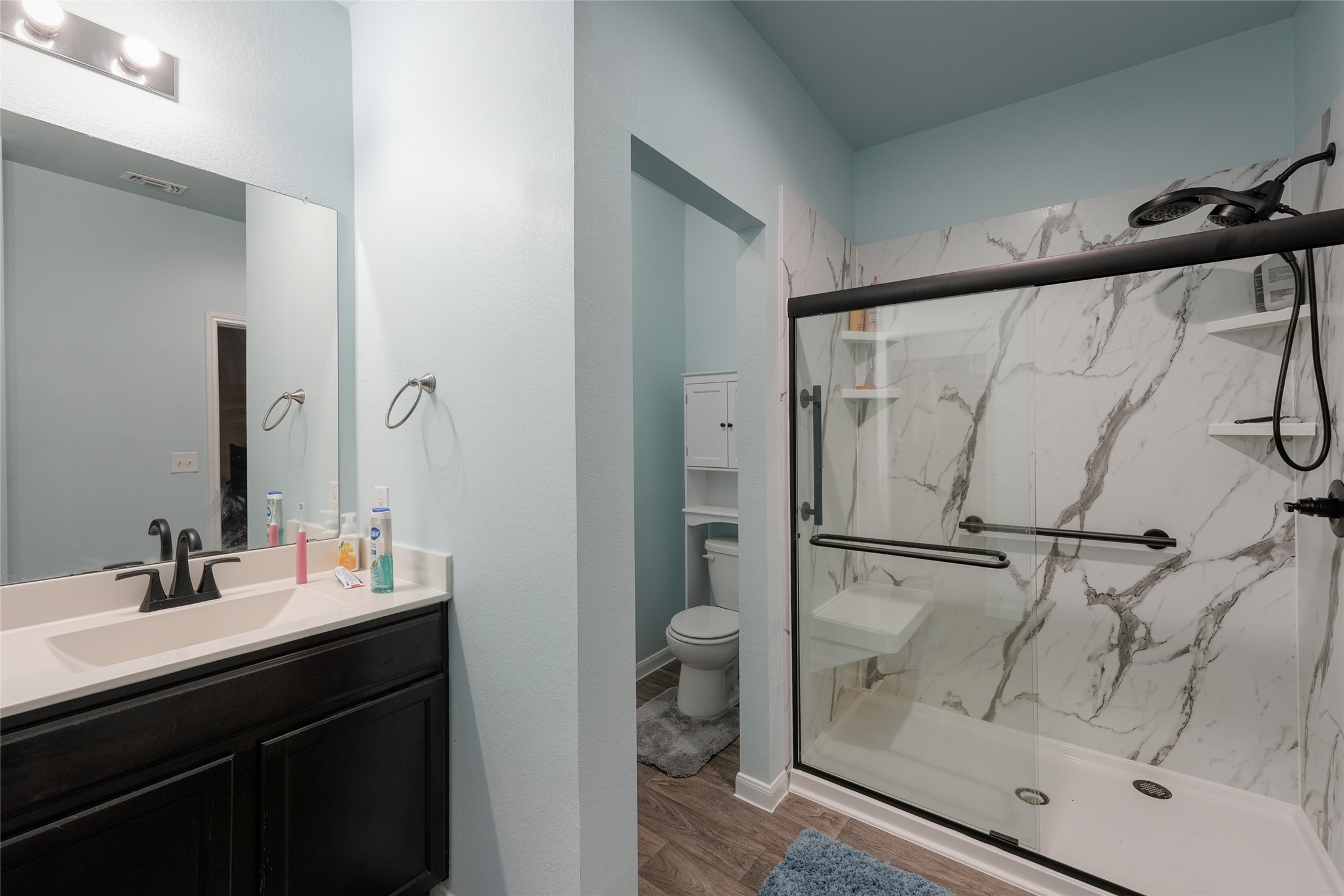 15105 Shell Bark Cove Austin, TX 78724 - Photo 21 of 30 A well-appointed bathroom with a modern shower and vanity.