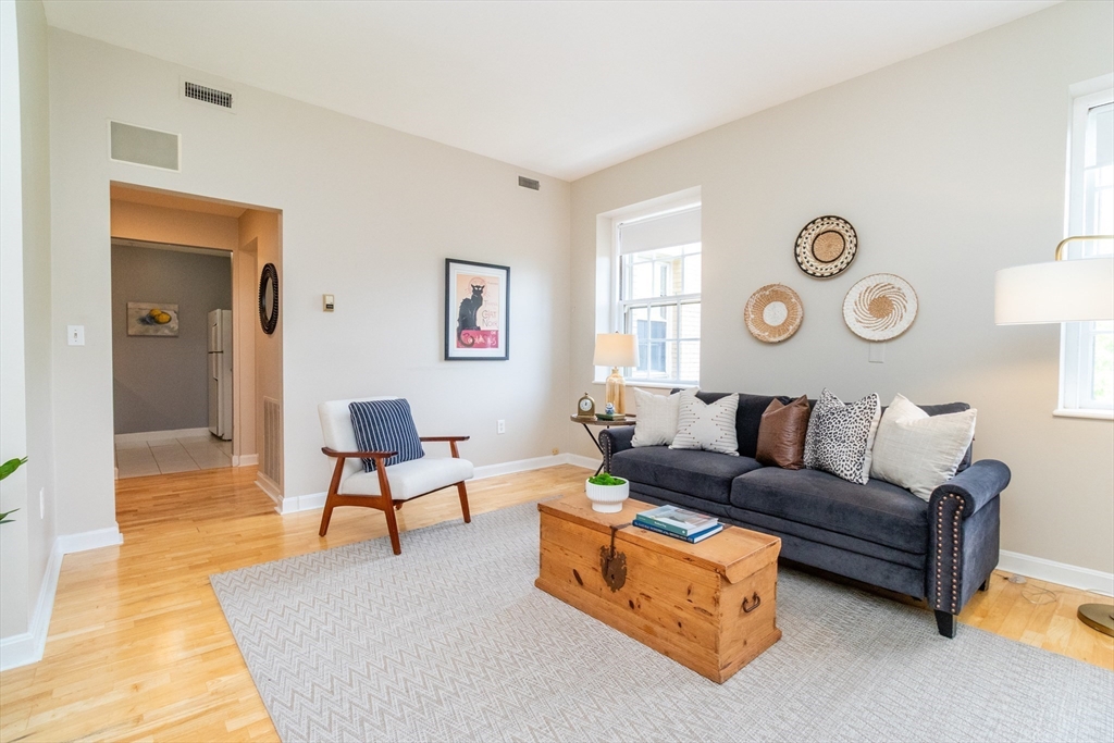 60e Glen Road, Unit 306 Brookline, MA 02445 - Photo 12 of 27 a living room with furniture and a window