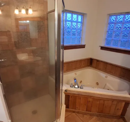 a white toilet sitting next to a bathroom sink and tub