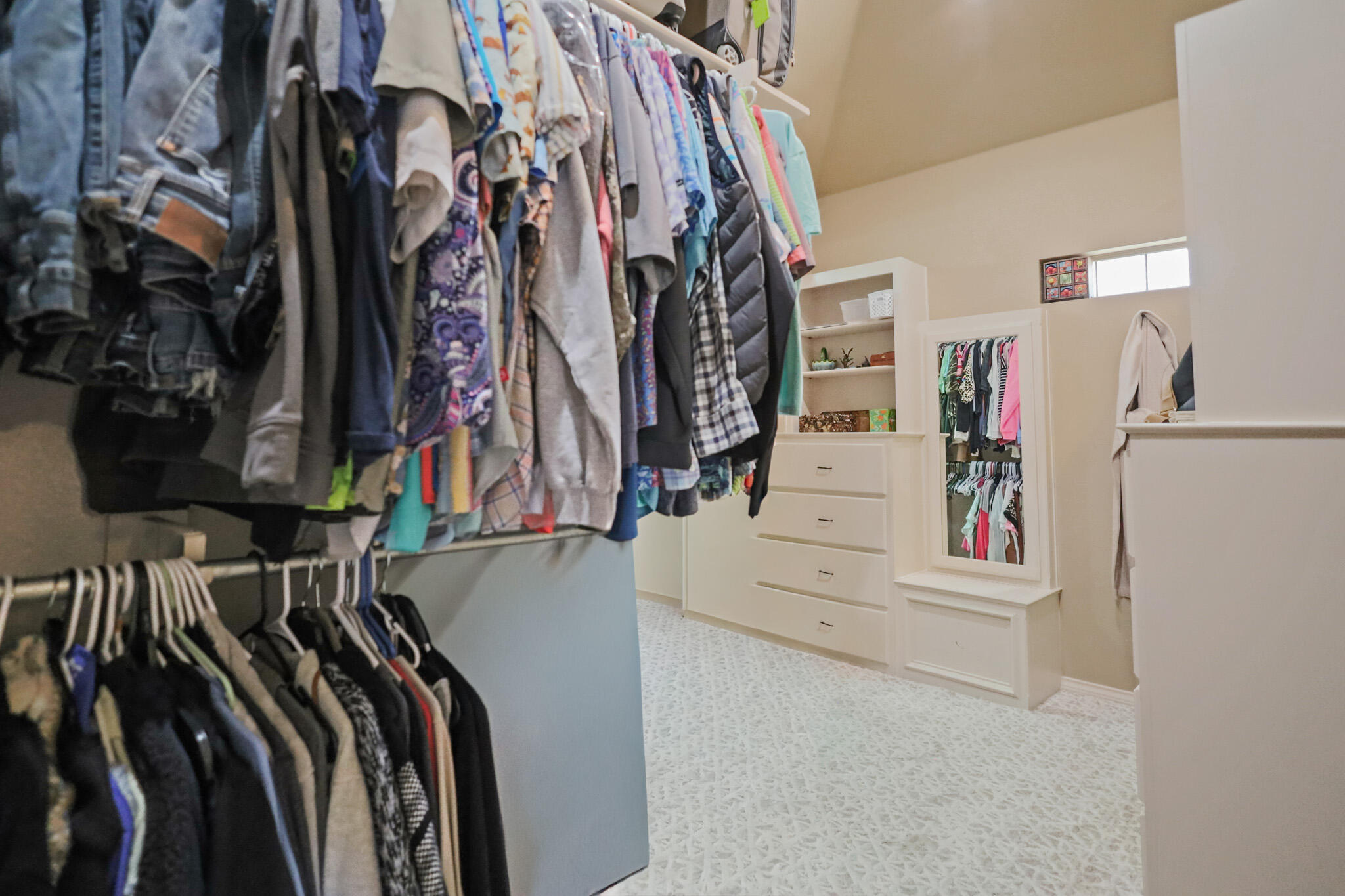 6005 93rd Street Lubbock, TX 79424 - Photo 15 of 31 a view of walk in closet with clothes and shoes