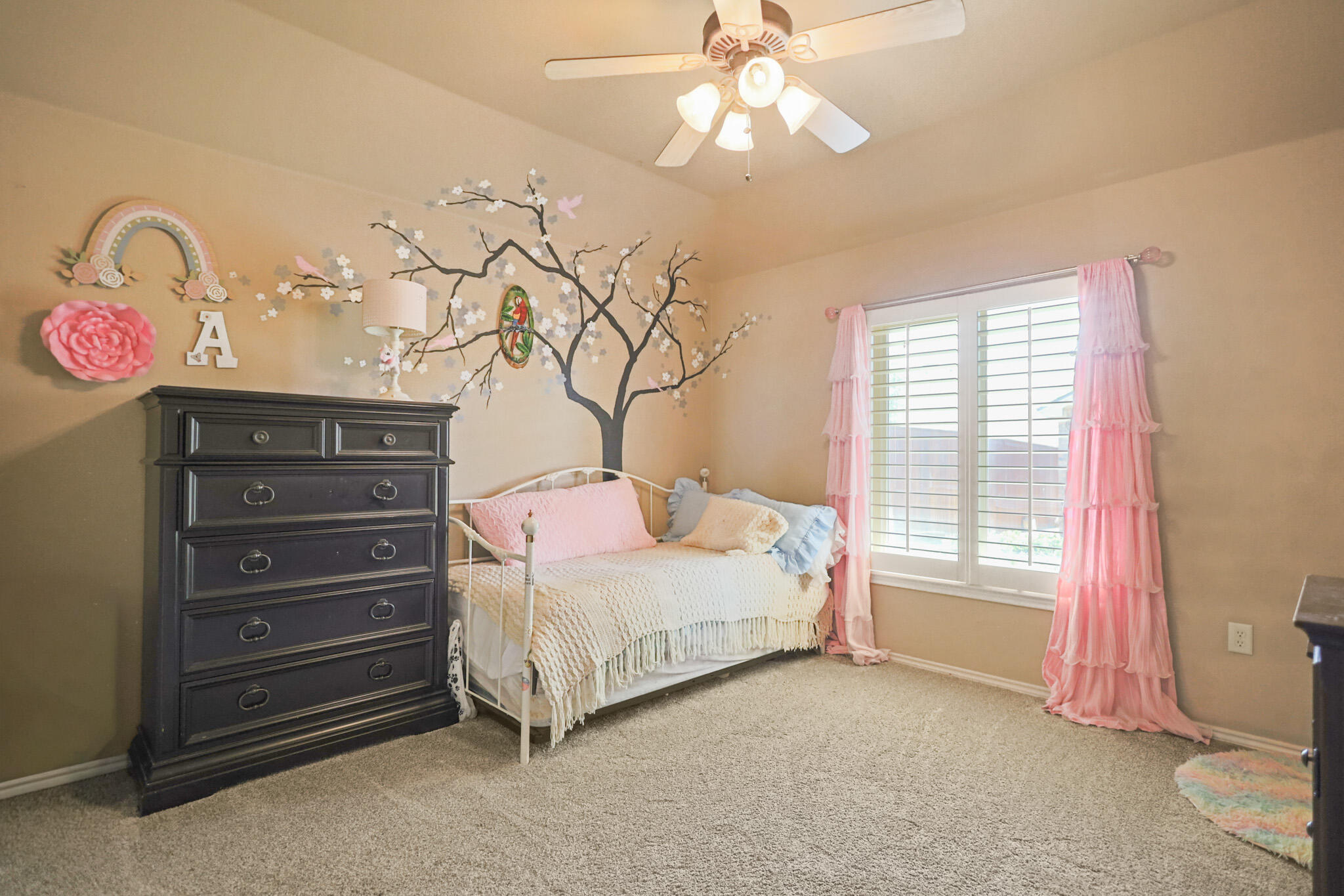 6005 93rd Street Lubbock, TX 79424 - Photo 18 of 31 a bedroom with a bed and a chandelier