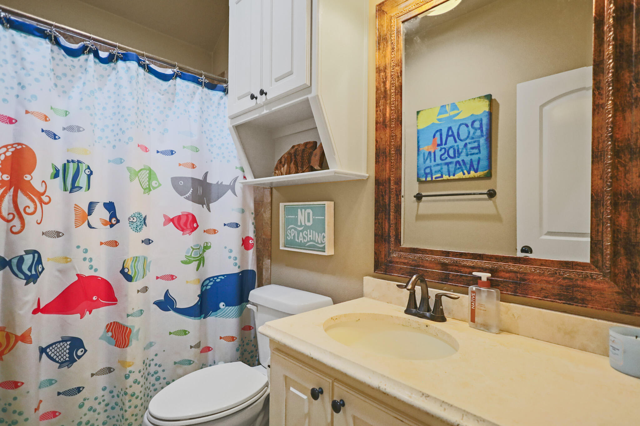 6005 93rd Street Lubbock, TX 79424 - Photo 20 of 31 a bathroom with a sink toilet and a mirror