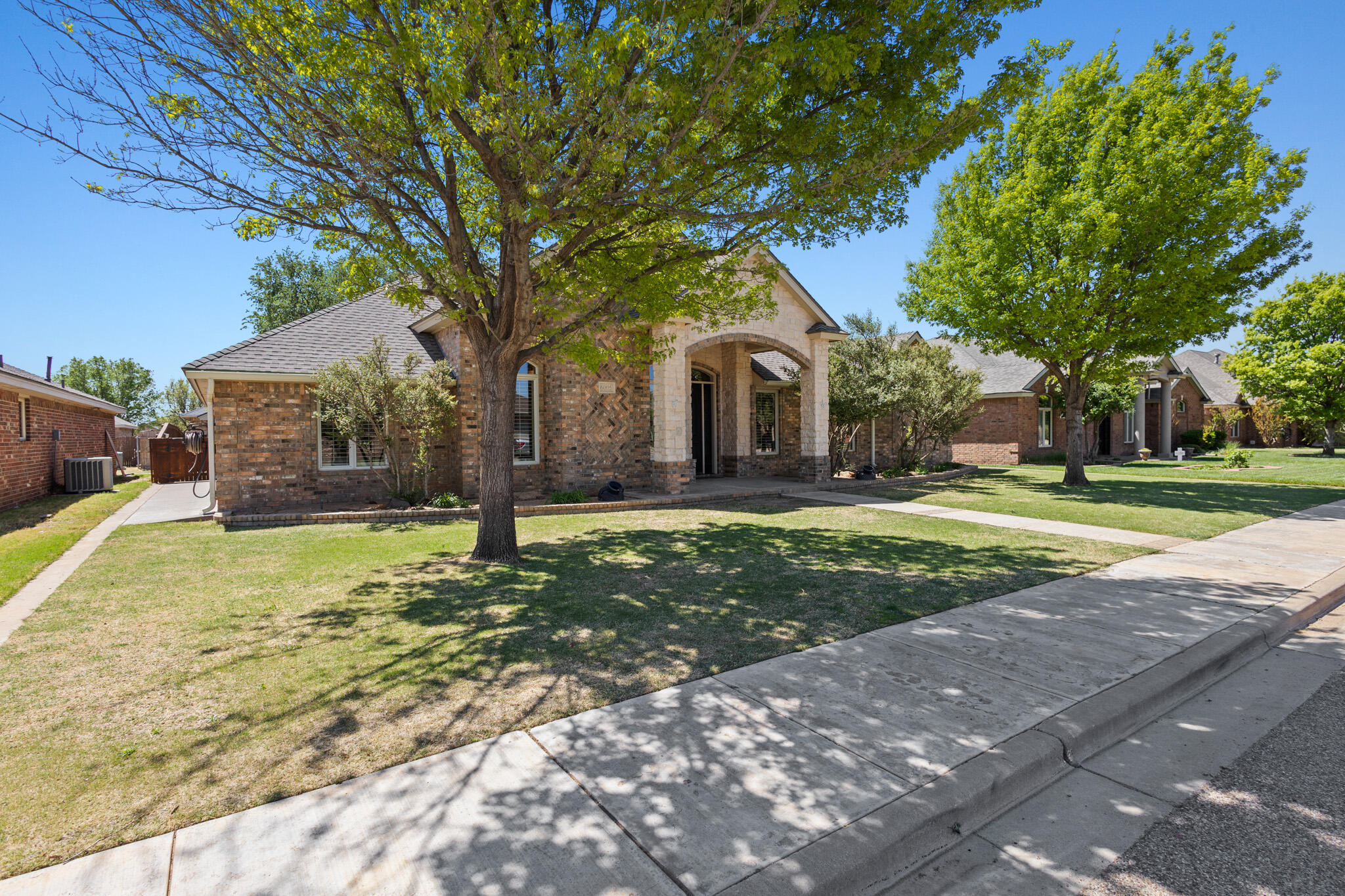 6005 93rd Street Lubbock, TX 79424 - Photo 2 of 31 a front view of a house with a yard