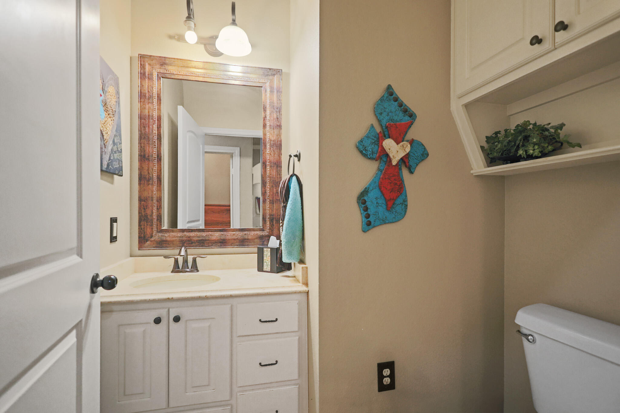 6005 93rd Street Lubbock, TX 79424 - Photo 22 of 31 a bathroom with a sink mirror and toilet