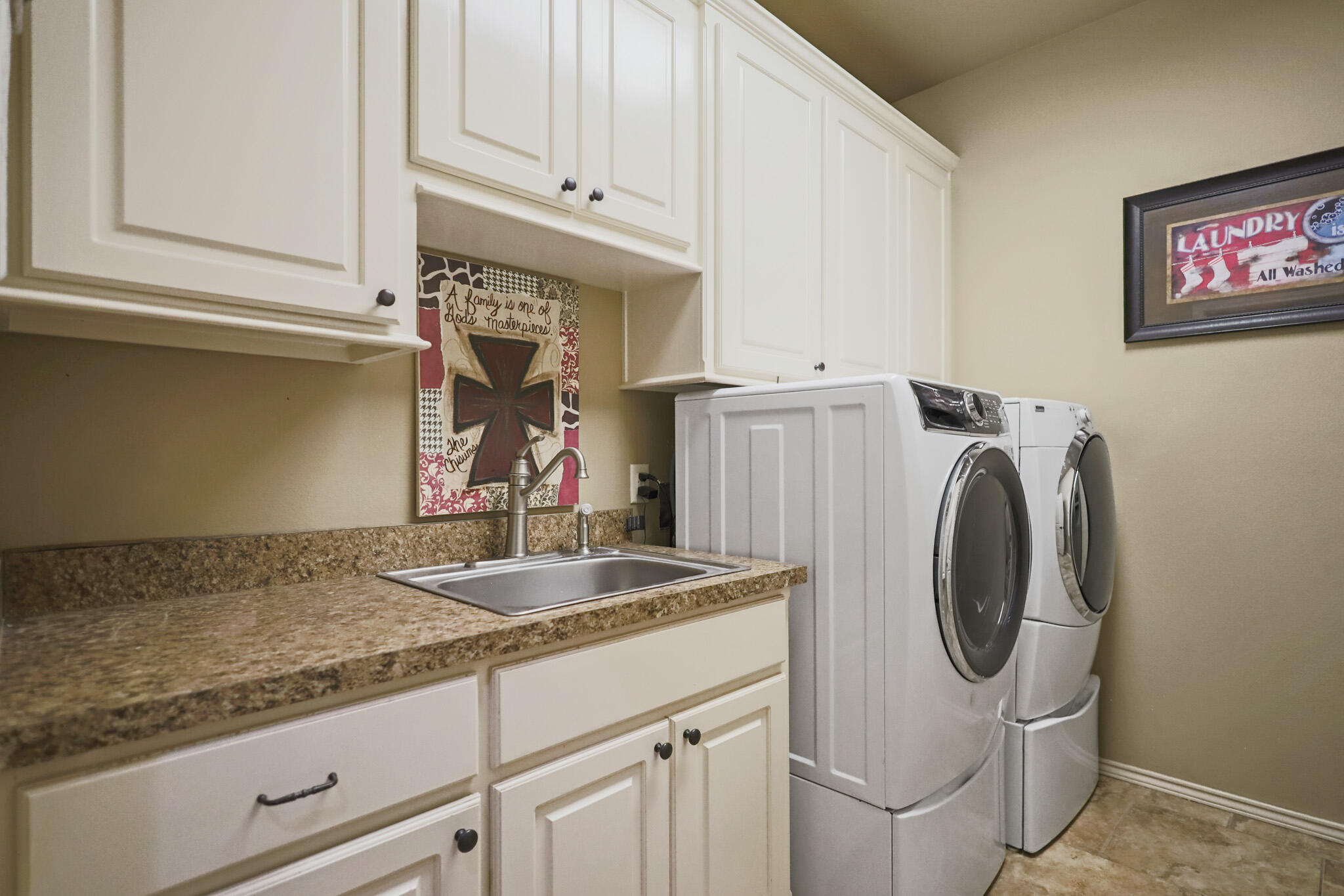 6005 93rd Street Lubbock, TX 79424 - Photo 23 of 31 a kitchen with sink cabinets and washing machine