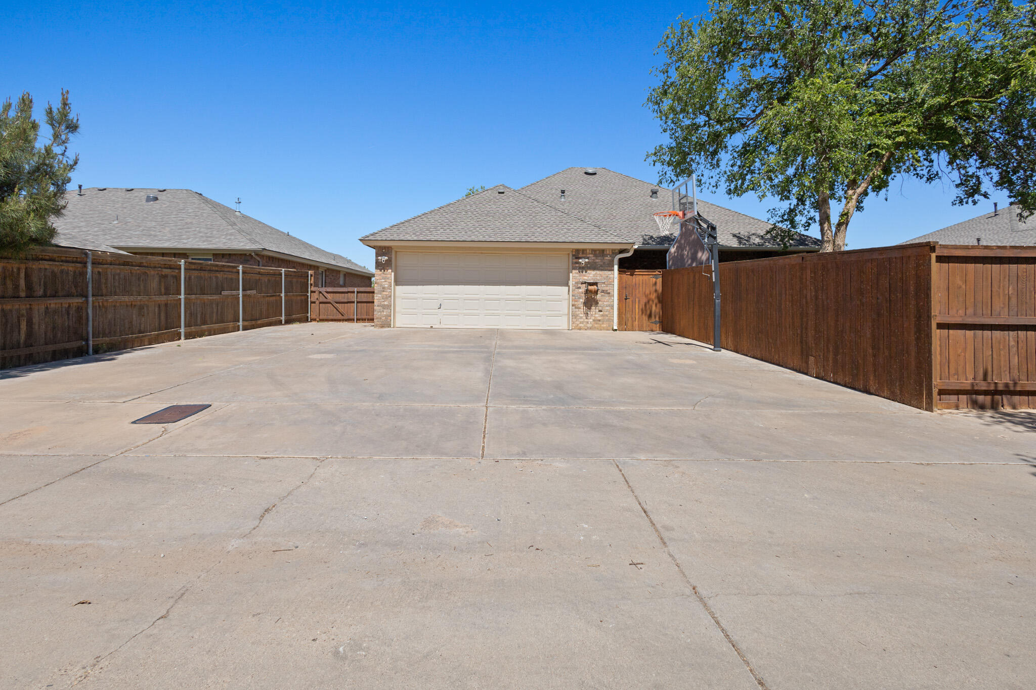 6005 93rd Street Lubbock, TX 79424 - Photo 31 of 31 a front view of a house with a yard and garage