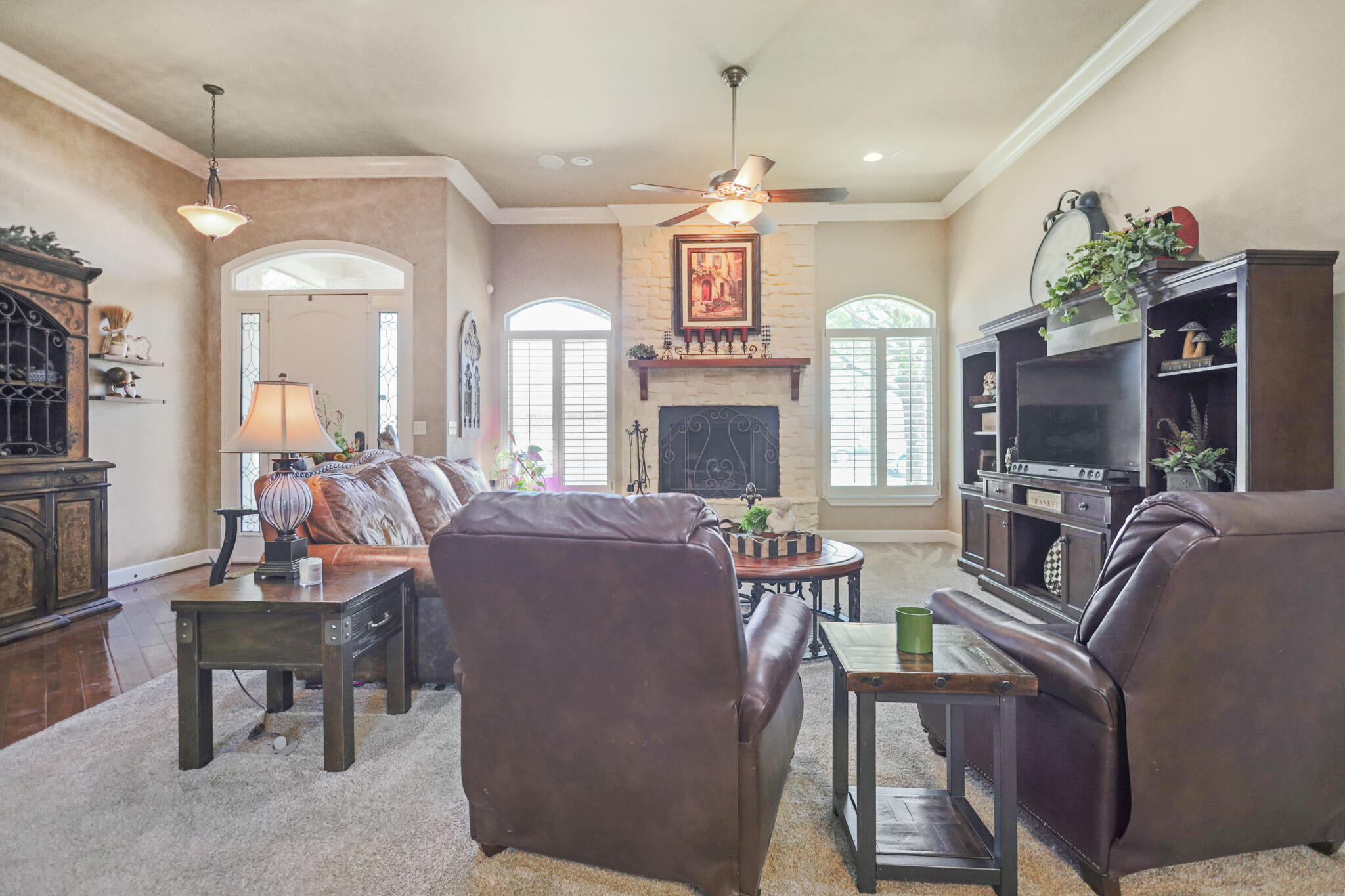 6005 93rd Street Lubbock, TX 79424 - Photo 5 of 31 a living room with fireplace furniture and a flat screen tv