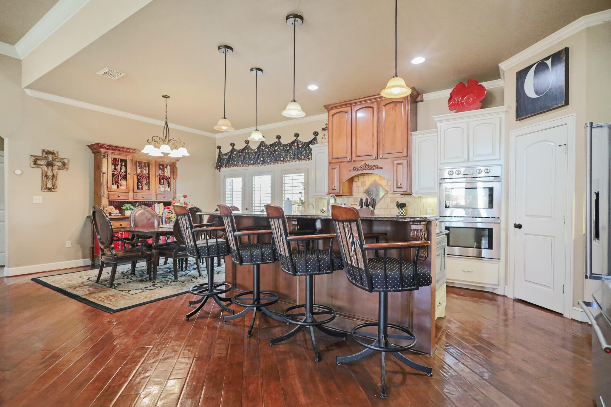 6005 93rd Street Lubbock, TX 79424 - Photo 8 of 31 a view of a room with lots of wooden furniture and windows