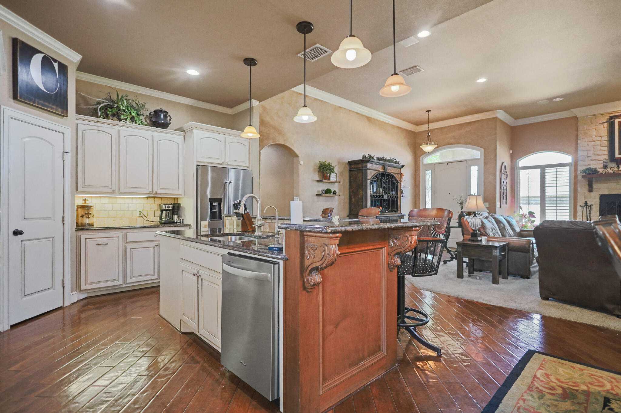 6005 93rd Street Lubbock, TX 79424 - Photo 9 of 31 a kitchen with stainless steel appliances kitchen island granite countertop a stove and cabinets