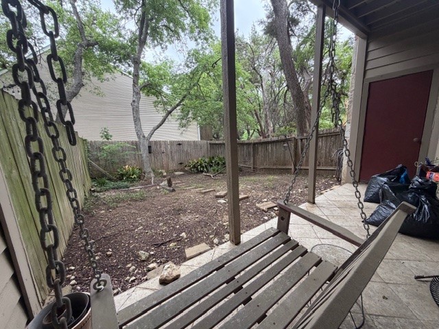 3809 Spicewood Springs Road, Unit 119 Austin, TX 78759 - Photo 12 of 14 The property features a fenced yard with mature trees and a paved patio area