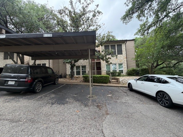 3809 Spicewood Springs Road, Unit 119 Austin, TX 78759 - Photo 13 of 14 This property features stone veneer exterior walls and siding, with mature trees providing natural shade