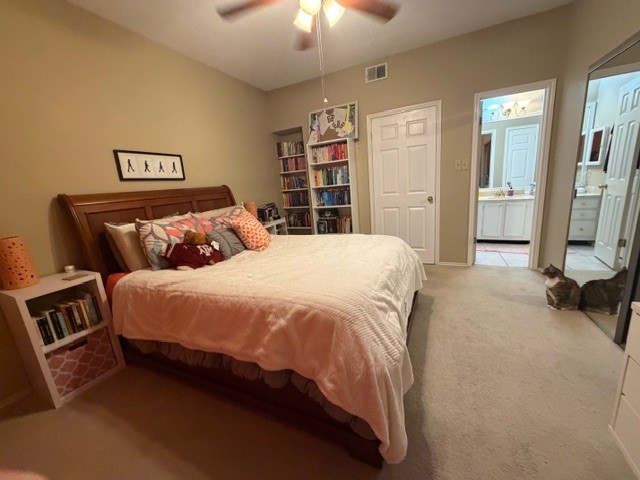 3809 Spicewood Springs Road, Unit 119 Austin, TX 78759 - Photo 10 of 14 Bedroom featuring a wooden bed frame, carpeted flooring, and a ceiling fan with integrated lighting