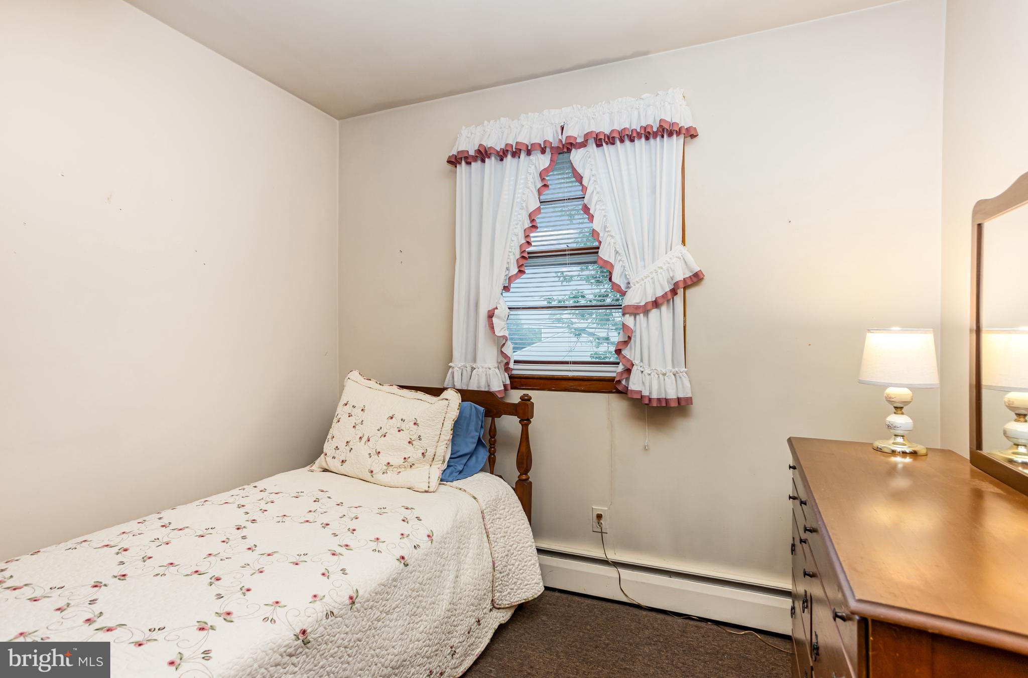 4234 Necker Avenue Baltimore, MD 21236 - Photo 13 of 29 a bedroom with a bed and a table in it