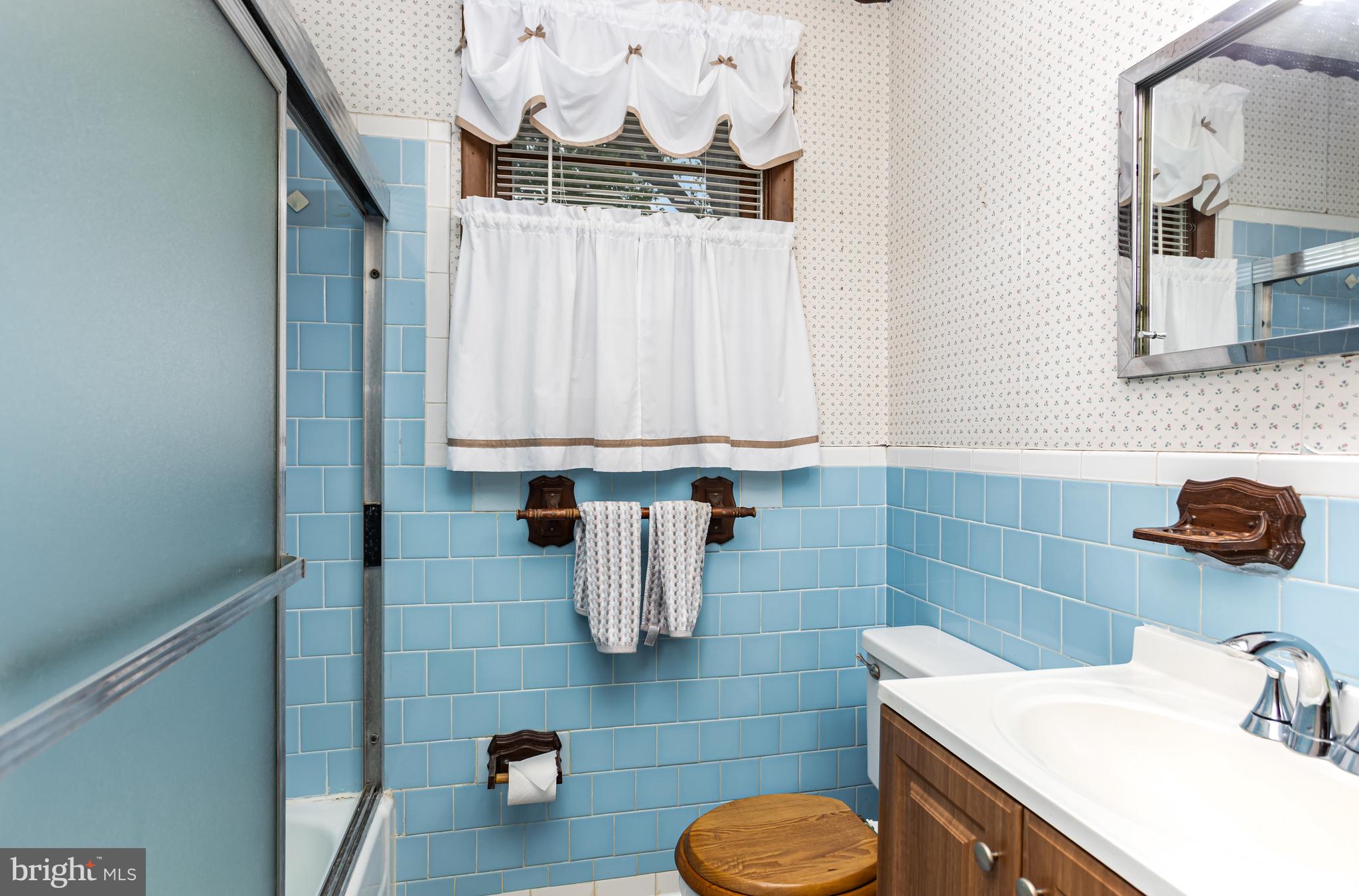 4234 Necker Avenue Baltimore, MD 21236 - Photo 15 of 29 a bathroom with a sink toilet and mirror